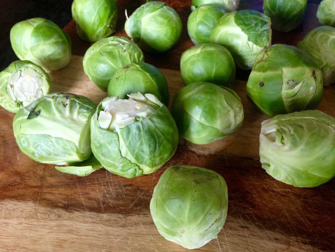 raw Brussels sprouts on a wooden board
