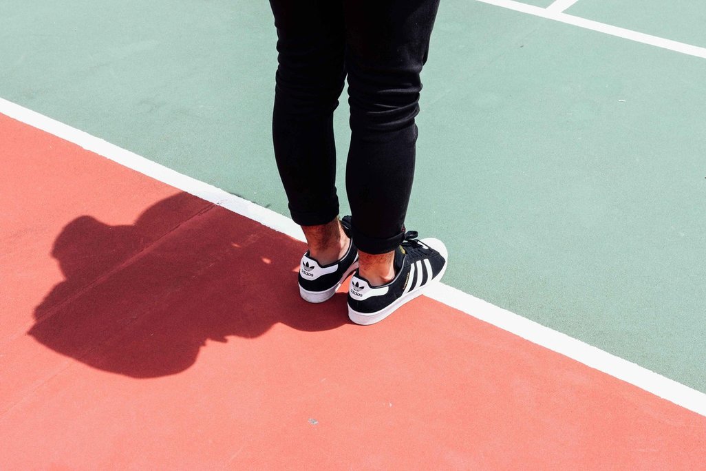 photo of woman's legs at the starting line of a running track