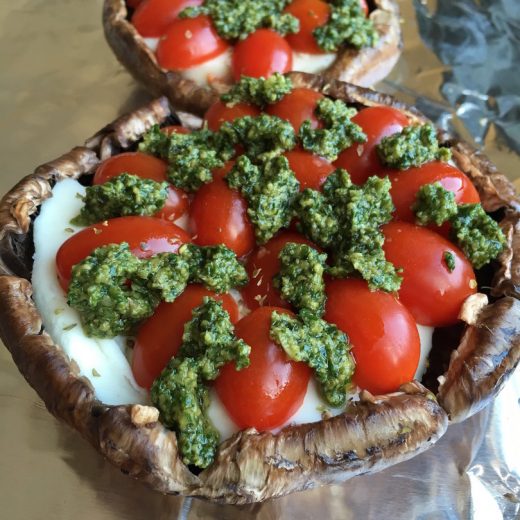 Portobello Mushroom cap stuffed with melted mozzarella cheese, tomatoes and pesto